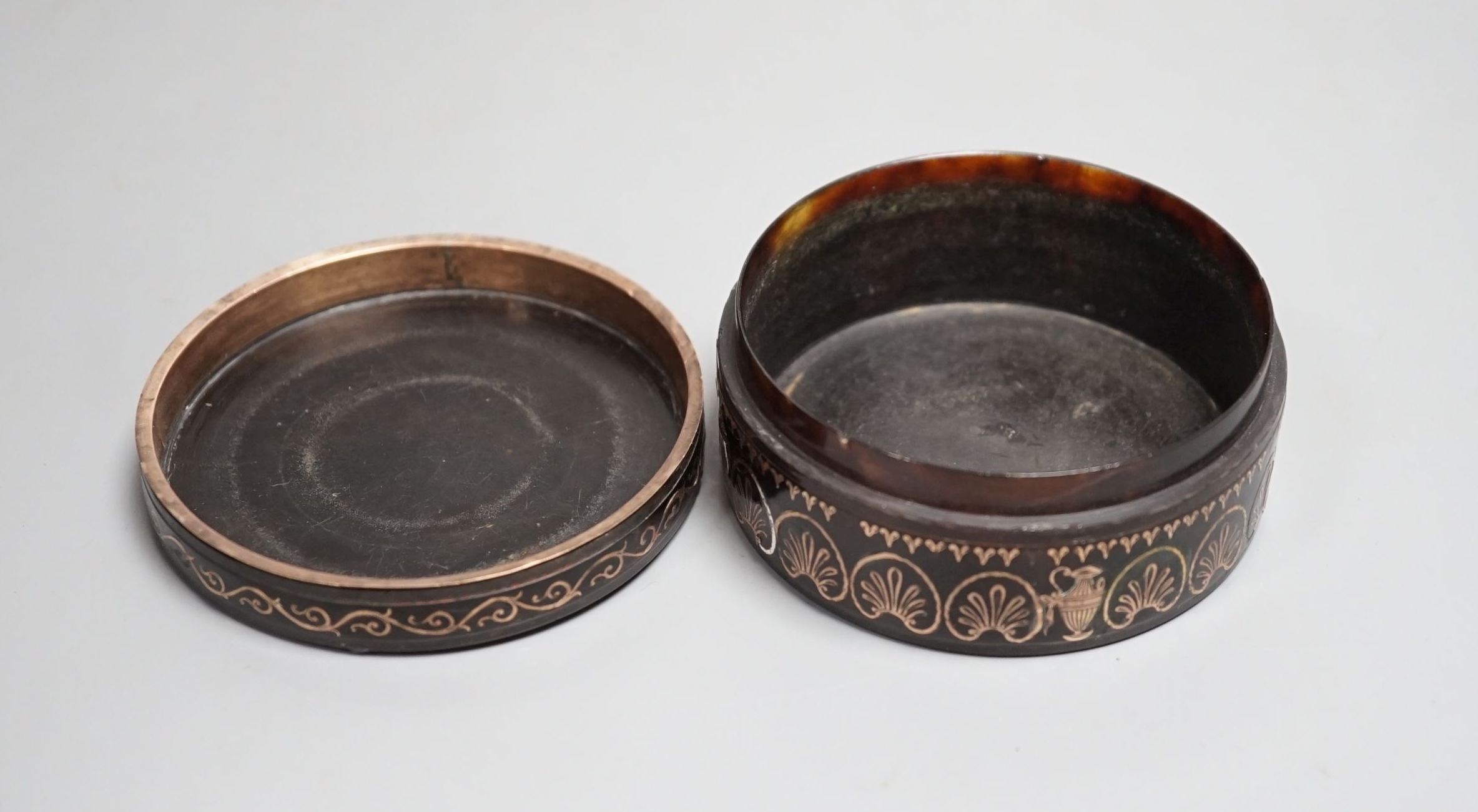 A 19th century yellow metal inlaid circular box and cover 8cm diameter